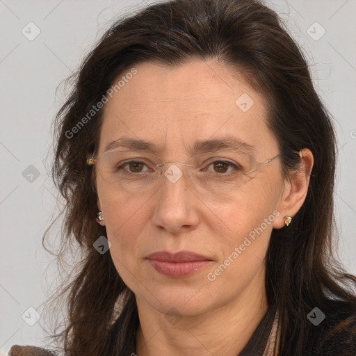 Joyful white adult female with long  brown hair and brown eyes