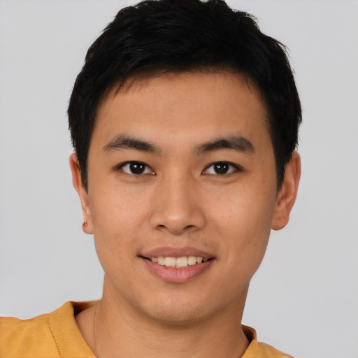 Joyful asian young-adult male with short  black hair and brown eyes