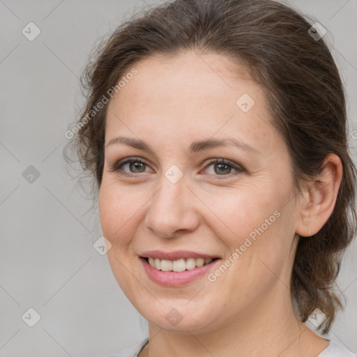 Joyful white adult female with medium  brown hair and brown eyes