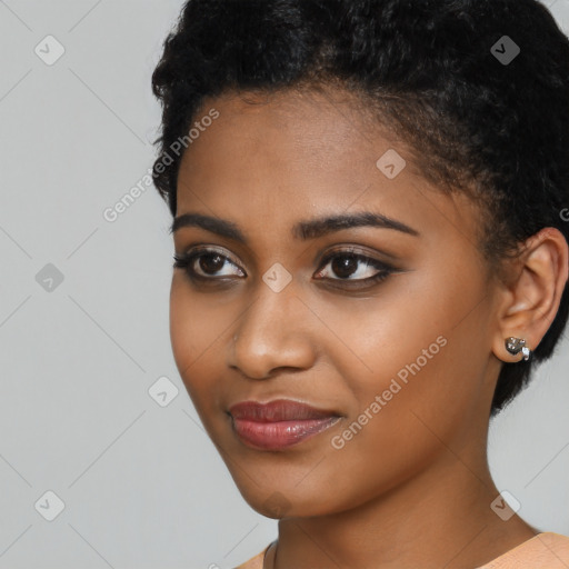 Joyful black young-adult female with short  black hair and brown eyes