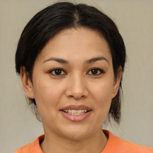 Joyful asian young-adult female with medium  brown hair and brown eyes