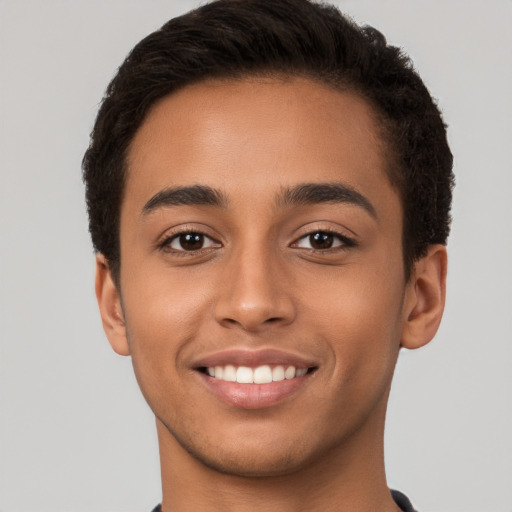 Joyful latino young-adult male with short  brown hair and brown eyes