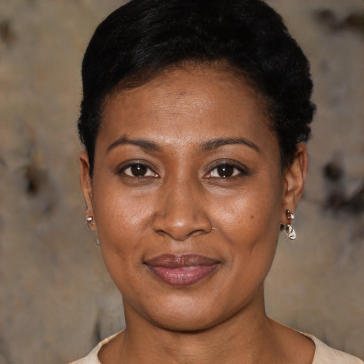 Joyful black young-adult female with short  black hair and brown eyes