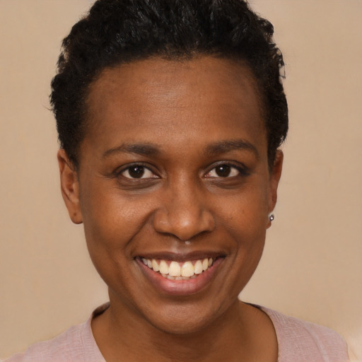 Joyful black young-adult female with short  black hair and brown eyes