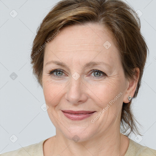 Joyful white adult female with medium  brown hair and grey eyes