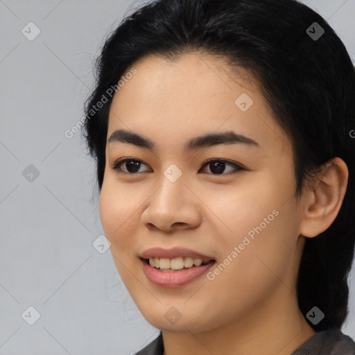 Joyful asian young-adult female with long  black hair and brown eyes