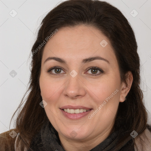 Joyful white adult female with long  brown hair and brown eyes