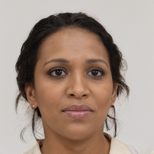 Joyful black young-adult female with medium  brown hair and brown eyes