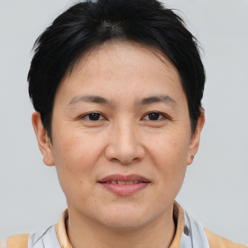 Joyful white adult female with short  black hair and brown eyes