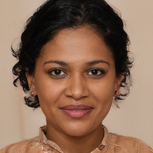 Joyful black young-adult female with medium  brown hair and brown eyes