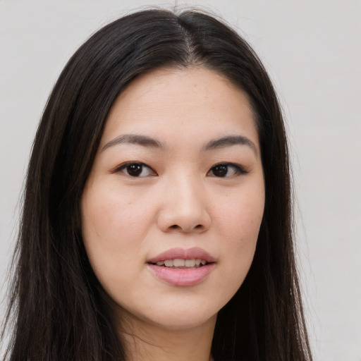 Joyful asian young-adult female with long  brown hair and brown eyes