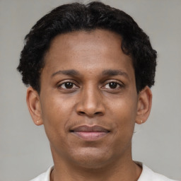 Joyful latino young-adult male with short  brown hair and brown eyes