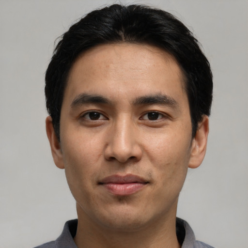 Joyful asian young-adult male with short  black hair and brown eyes