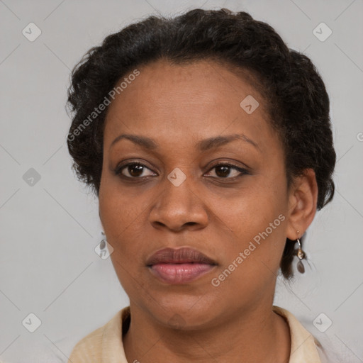 Joyful black adult female with short  brown hair and brown eyes