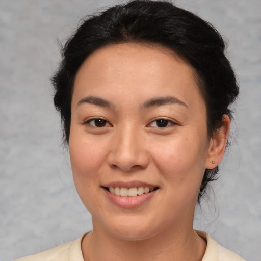 Joyful asian young-adult female with medium  brown hair and brown eyes