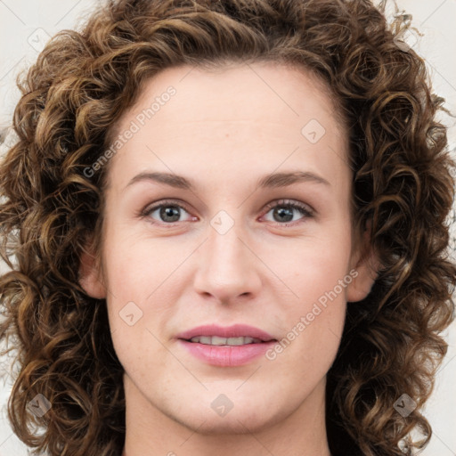 Joyful white young-adult female with long  brown hair and green eyes