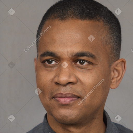 Joyful black adult male with short  black hair and brown eyes