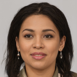 Joyful latino young-adult female with long  brown hair and brown eyes