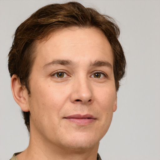 Joyful white adult male with short  brown hair and green eyes