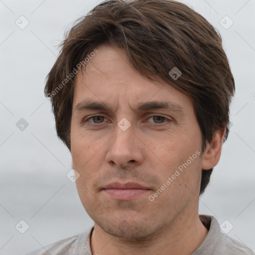 Joyful white adult male with short  brown hair and grey eyes