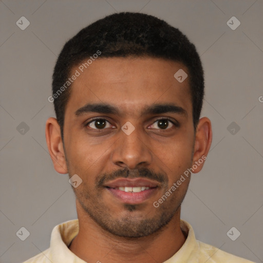 Joyful black young-adult male with short  brown hair and brown eyes