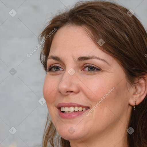 Joyful white adult female with medium  brown hair and grey eyes