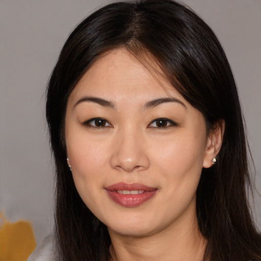 Joyful asian young-adult female with medium  brown hair and brown eyes