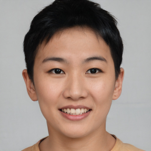 Joyful asian young-adult female with short  black hair and brown eyes