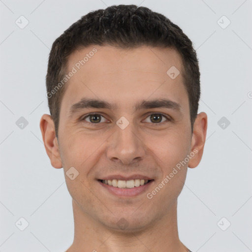 Joyful white young-adult male with short  brown hair and brown eyes