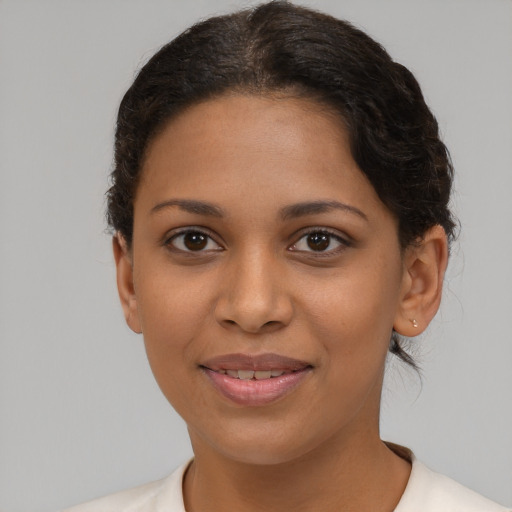 Joyful black young-adult female with short  brown hair and brown eyes