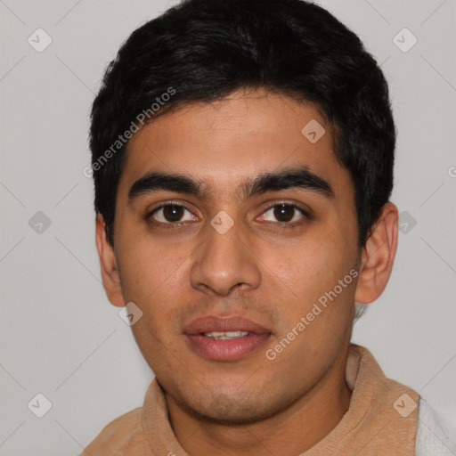 Joyful latino young-adult male with short  black hair and brown eyes