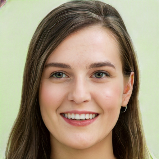 Joyful white young-adult female with long  brown hair and green eyes