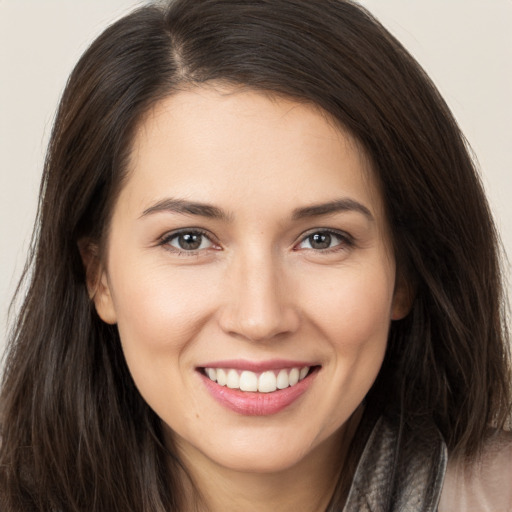 Joyful white young-adult female with long  brown hair and brown eyes