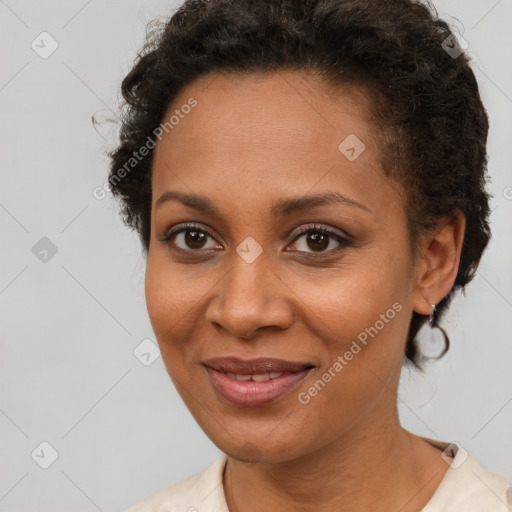 Joyful black young-adult female with short  brown hair and brown eyes