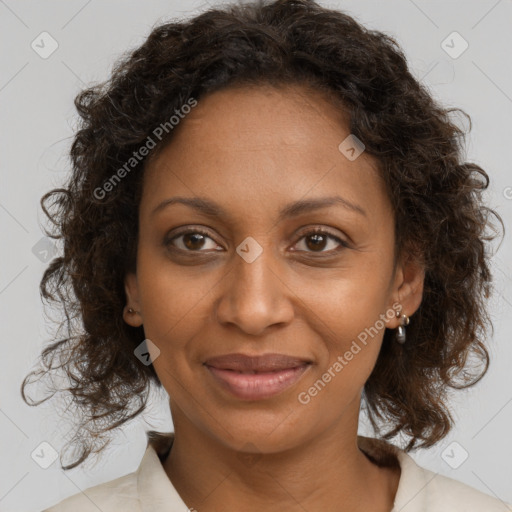 Joyful black adult female with medium  brown hair and brown eyes