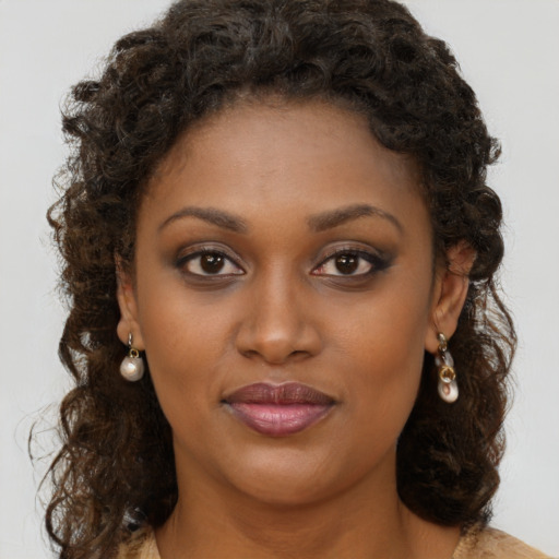 Joyful black young-adult female with medium  brown hair and brown eyes