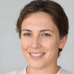 Joyful white adult female with medium  brown hair and brown eyes