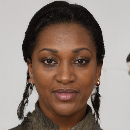 Joyful black adult female with medium  black hair and brown eyes