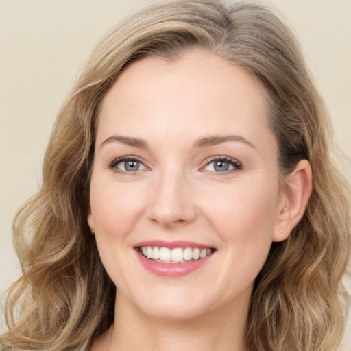 Joyful white young-adult female with long  brown hair and green eyes