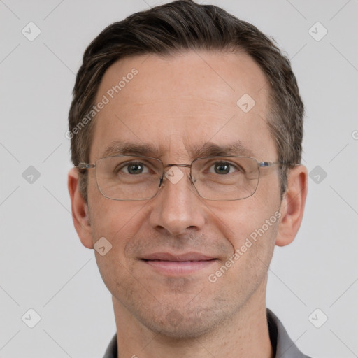 Joyful white adult male with short  brown hair and grey eyes