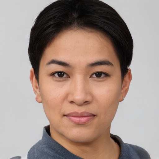Joyful asian young-adult female with short  black hair and brown eyes