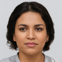 Joyful latino young-adult female with medium  brown hair and brown eyes