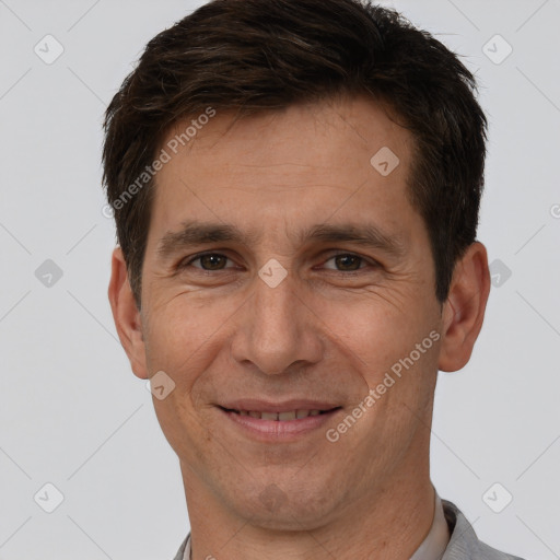 Joyful white adult male with short  brown hair and brown eyes