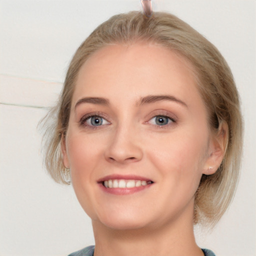 Joyful white young-adult female with medium  brown hair and blue eyes