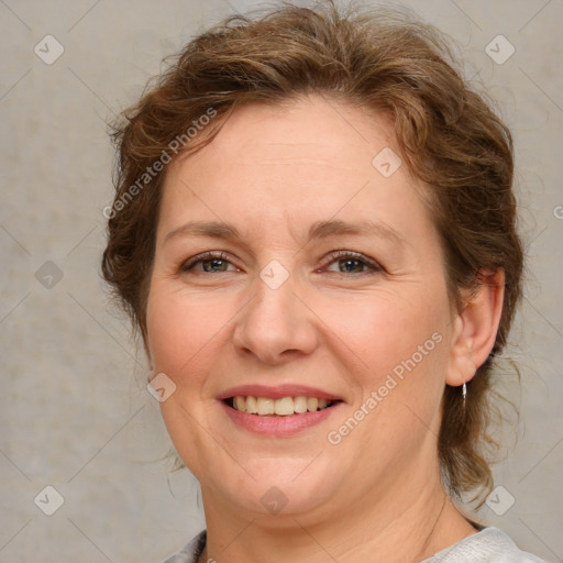 Joyful white adult female with medium  brown hair and blue eyes