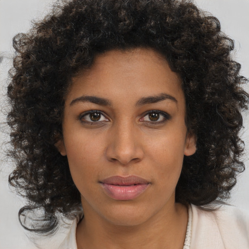 Neutral black young-adult female with medium  brown hair and brown eyes