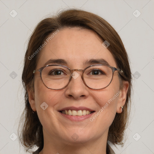 Joyful white adult female with medium  brown hair and blue eyes