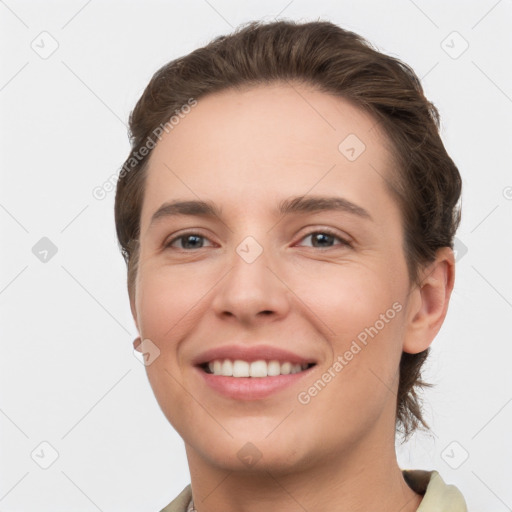 Joyful white young-adult female with short  brown hair and brown eyes