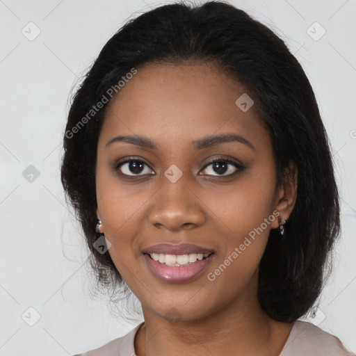 Joyful black young-adult female with long  black hair and brown eyes