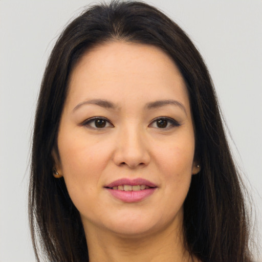 Joyful asian young-adult female with long  brown hair and brown eyes